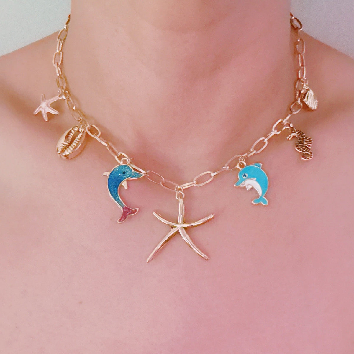 Women's Ocean Play Charm Necklace | Dolphin, Starfish, Seahorse & Shell Design