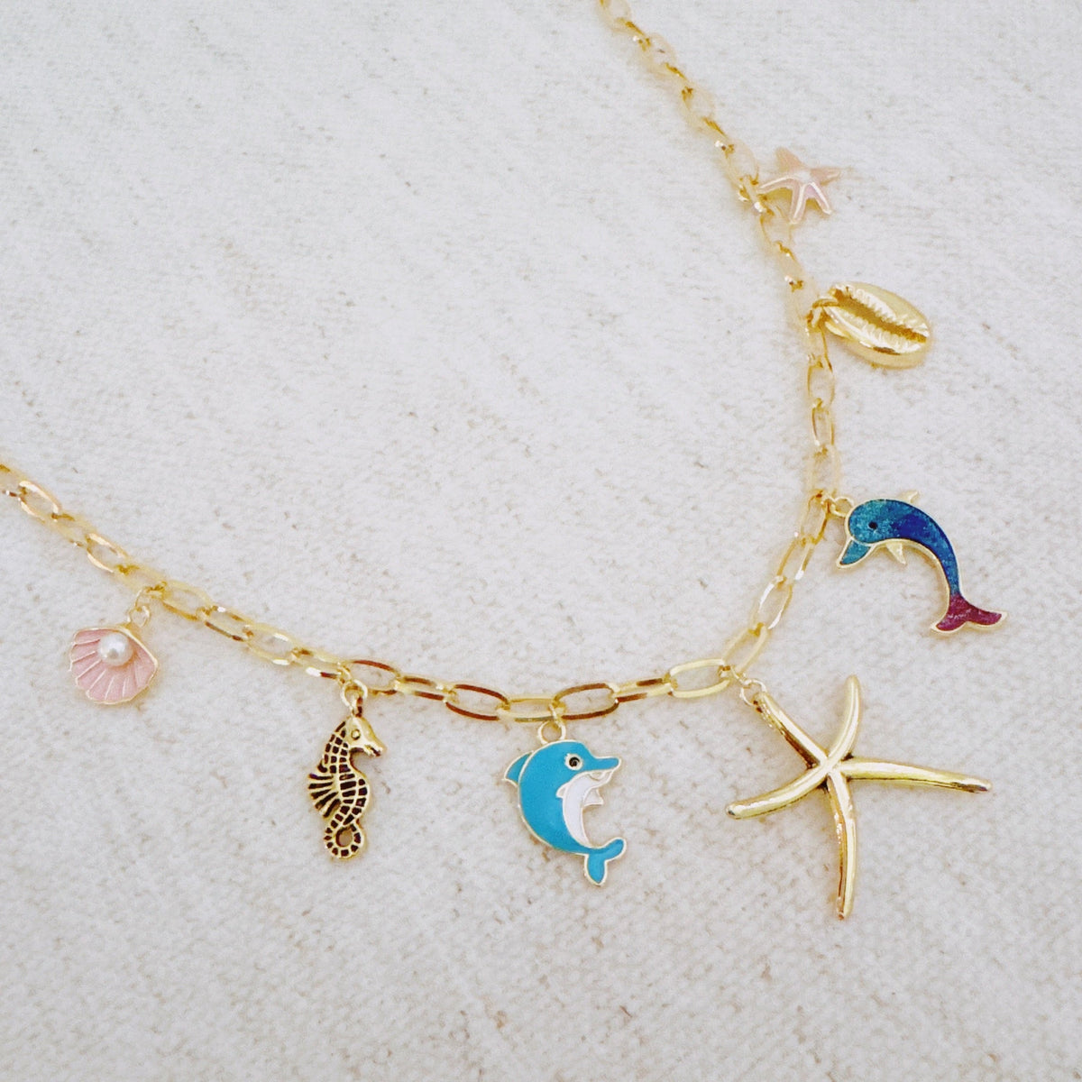 Women's Ocean Play Charm Necklace | Dolphin, Starfish, Seahorse & Shell Design