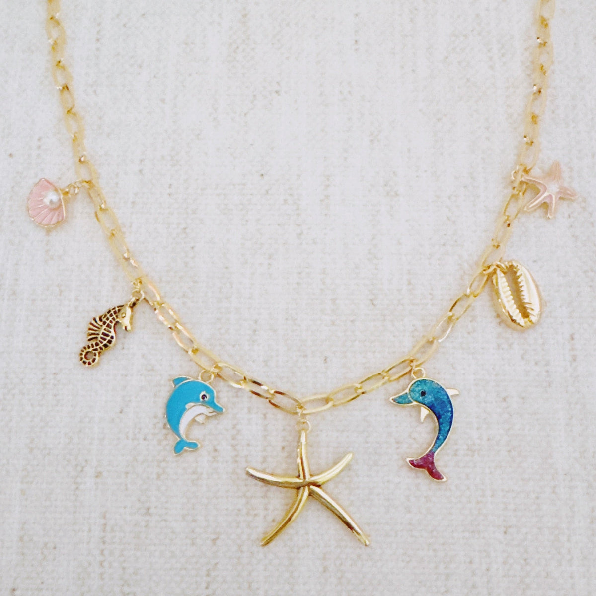 Women's Ocean Play Charm Necklace | Dolphin, Starfish, Seahorse & Shell Design